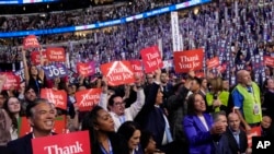 Delegates cheer as President Joe Biden speaks during the first day of Democratic National Convention, Aug. 19, 2024, in Chicago.