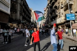 People march from Tahrir Square to the downtown district in the center of Cairo during a protest supporting the Palestinian people following Friday noon prayers, amid the ongoing battles between Israel and the Palestinian group Hamas, Oct. 20, 2023.