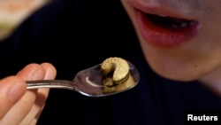 Shunnosuke Suga eats beetle larvae, as he eats Almond tofu with beetle larvae at Take-Noko cafe in Tokyo, Japan, July 21, 2023. (REUTERS/Kim Kyung-Hoon)