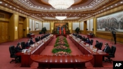 Visiting Solomon Islands Prime Minister Manasseh Sogavare, fifth from right, talks to his Chinese counterpart Li Qiang, fifth from left, during a meeting at the Great Hall of the People in Beijing, July 10, 2023.