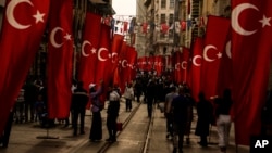 People walk along main Istiklal street in Istanbul, Oct. 26, 2023.