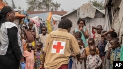 FILE - Red Cross officials create awareness of mpox in the Don Bosco refugee camp in Goma, Democratic Republic of the Congo, Aug. 22, 2023.