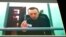 Russian opposition leader Alexey Navalny is seen on a TV screen as he appears in a video link provided by the Russian Federal Penitentiary Service from the colony in Melekhovo, Vladimir region, during a hearing at the Russian Supreme Court in Moscow, Russia, June 22, 2023. 