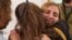 This picture released by Israel's army, courtesy of the hostages' families, on Nov. 25, 2023, shows former Hamas captive Danielle Aloni embracing a relative at a hospital in Israel. Aloni and her daughter became friends with Nutthawaree Munkan, of Thailand, while being held.
