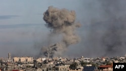 A picture taken from Rafah shows smoke billowing over Khan Yunis in the southern Gaza Strip during Israeli bombardment on Jan. 13, 2024.