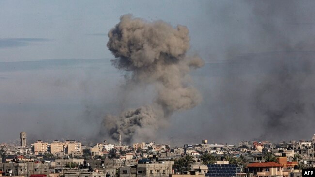 A picture taken from Rafah shows smoke billowing over Khan Yunis in the southern Gaza Strip during Israeli bombardment on Jan. 13, 2024.