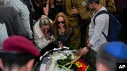 Mourners gather in grief during the funeral of Israeli solider Staff sergeant David Sasson, in Netanya, Israel, March 7, 2024.