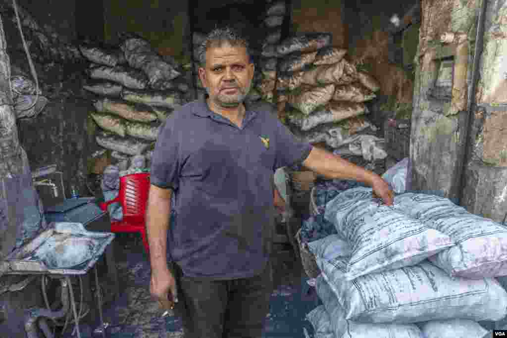 Mohamed, a coal vendor, says, “Our prices didn't increase this year, but who wants to roast expensive meat when they can benefit from the soup? I only brought half the amount of coal, and almost nothing has sold yet.” (Hamada Elrasam/VOA)