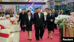 North Korean leader Kim Jong Un walks with his daughter, Kim Ju Ae, and his wife, Ri Sol Ju, while attending a banquet to celebrate the 75th anniversary of the Korean People's Army, in Pyongyang, Feb. 7, 2023. (Korean Central News Agency via Reuters)