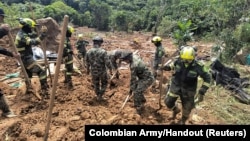 Colombian Army rescuers search for survivors of a landslide caused by heavy rains in Choco, Colombia, Jan. 13, 2024. (Colombian Army/Handout via Reuters)