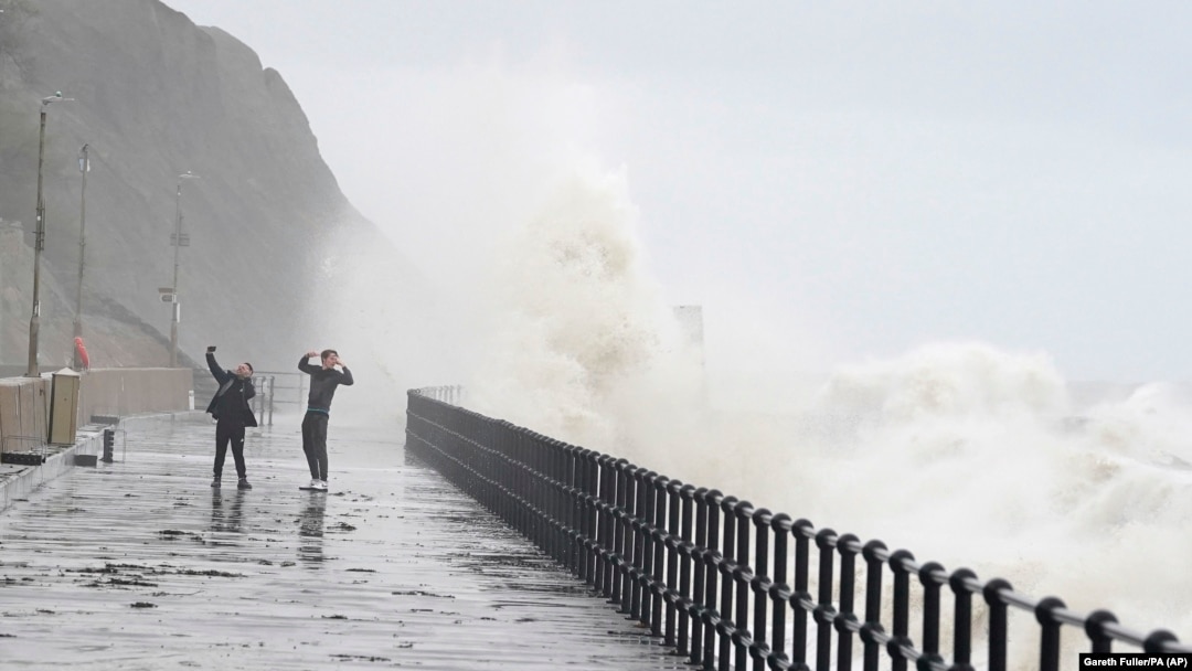 People stand on the promenade in Folkestone, England, Nov. 2, 2023, as Storm Ciaran brings high winds and heavy rain to the southern coast of England.