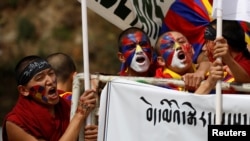 Tibetans shout slogans during a protest march held to mark the 65th anniversary of the Tibetan uprising against Chinese rule, in the northern hill town of Dharamsala, India, March 10, 2024.