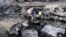 Luis Quinonez surveys the damage to his property after the Highland Fire passed through, Oct. 31, 2023, in Aguanga, California.