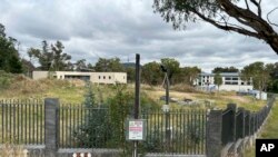 An unoccupied building, left, sits on the grounds of a proposed new Russian embassy, across from another building, right, that is part of the Chinese embassy near the Australian parliament in Canberra, Feb. 28, 2023.