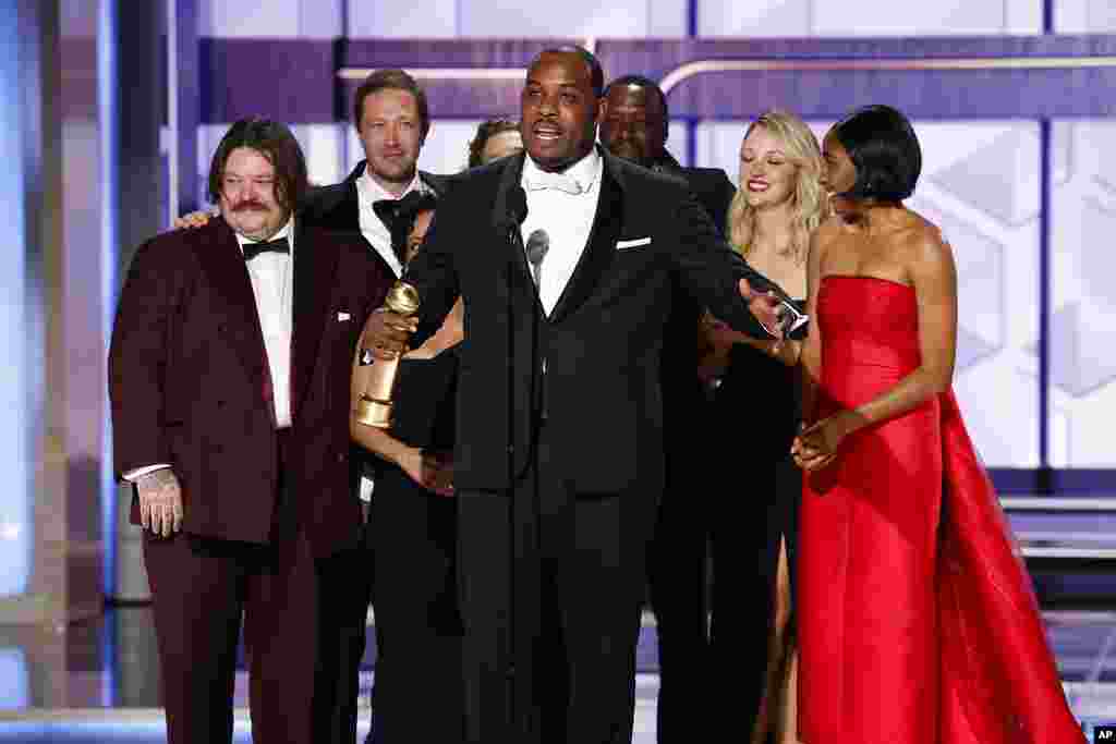 This image released by CBS shows Lionel Boyce, center, with the cast of &quot;The Bear&quot; as they accept the award for best television series - musical or comedy during the 81st Annual Golden Globe Awards in Beverly Hills, Calif., on Sunday, Jan. 7, 2024.&nbsp;
