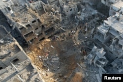 Palestinians gather at the site of Israeli strikes on houses in Maghazi, in the central Gaza Strip, Nov. 3, 2023.