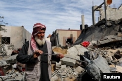 A Palestinian stands at the site of an Israeli strike on a house, amid the ongoing conflict between Israel and Hamas, in Rafah in the southern Gaza Strip, March 1, 2024.