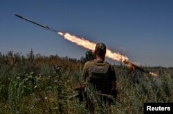 Ukrainian servicemen fire a Partyzan small multiple rocket launch system toward Russian troops near a front line in the Zaporizhzhia region, Ukraine July 13, 2023.