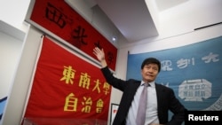 Zhou Fengsuo, curator of the Tiananmen June 4th Memorial permanent exhibition, speaks in front of a banner used to bind bullet wounds of a student near Tiananmen Square China on June 4, 1989, in New York, June 1, 2023. 