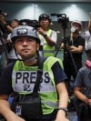 FILE - In a sign of protest against the police using force against the media, press photographers wear protective gear during a police media conference in Hong Kong, Sept. 9, 2019. Once a model for press freedom in the Asia region, Hong Kong's ranking has plummeted.