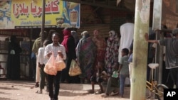FILE: People line up in front of a bakery during a cease-fire in Khartoum, Sudan, on May 27, 2023, as the current cease-fire took effect. Authorities say the halt is largely holding in Khartoum. 