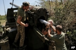 Service members of the 24th Mechanized Brigade fire a 152mm self-propelled howitzer toward Russian positions near Chasiv Yar town, in Donetsk region, Ukraine, Aug. 20, 2024. (Ukrainian 24th Mechanised Brigade via AP)