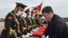 FILE - Chinese Ambassador to South Korea Xing Haiming covers caskets containing the remains of Chinese soldiers with a Chinese national flag during the handing over ceremony at the Incheon International Airport in Incheon, Sept. 16, 2022 South Korea.