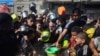 FILE - Palestinians crowd together as they wait for food distribution in Rafah, southern Gaza Strip, Nov. 8, 2023. 