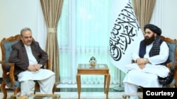 Pakistan's special envoy on Afghanistan, Asif Durrani, (L) meets with Taliban Foreign Minister Amir Khan Muttaqi (R), Sept. 21, 2023, in this photo released by the Taliban.