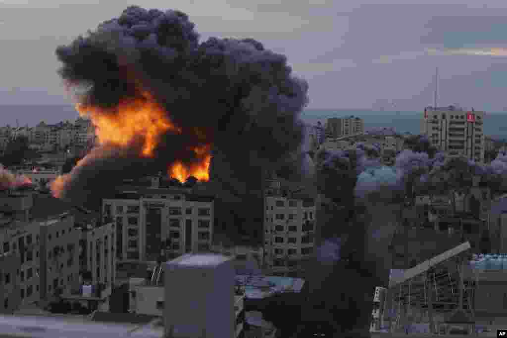 Fire and smoke rise from an explosion on a Palestinian apartment tower following an Israeli air strike in Gaza City on Oct. 7, 2023.