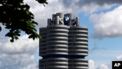 FILE - Clouds hang over the headquarters of German carmaker BMW, in Munich, Germany, May 14, 2021.