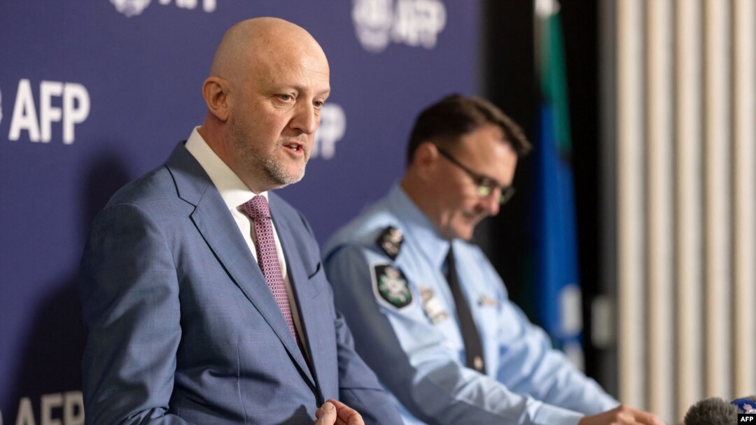 FILE - A handout photo taken on July 12, 2024, and received from the Australian Federal Police shows Australia's Director-General of Security and head of the Australian Security Intelligence Organization Mike Burgess, left, 