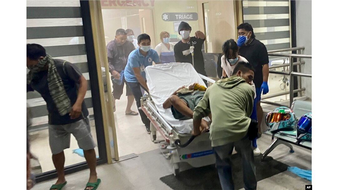 Patients at Manuel J. Santos Hospital in Butuan City, southern Philippines, are evacuated after an earthquake, Dec. 2, 2023.