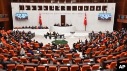 Turkish lawmakers follow the debate of Sweden's bid to join NATO at the Turkish Parliament in Ankara, Turkey, Jan. 23, 2024.