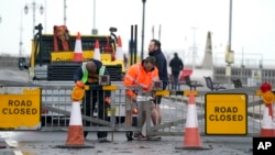Workers close the Clarence Esplanade as Storm Ciaran brings high winds and heavy rain along the south coast of England, in Southsea, Portsmouth, Nov. 2, 2023.