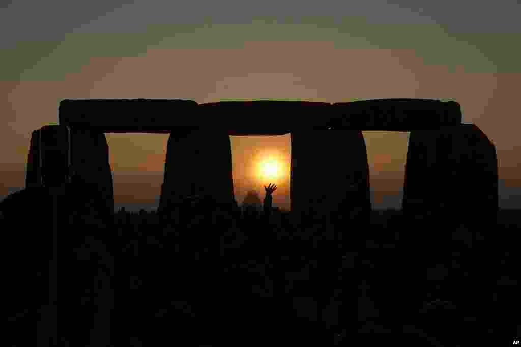 Revelers gather at the ancient stone circle Stonehenge to celebrate the Summer Solstice, the longest day of the year, near Salisbury, England.