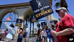 Writers and actors picket outside Paramount studios in Los Angeles, July 14, 2023. This was the first day actors formally joined the picket lines, more than two months after screenwriters began striking in their bid for better pay and working conditions.