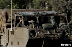 An Israeli soldier sits inside a military vehicle, near the Israel-Gaza border, in southern Israel, Jan. 15, 2024.