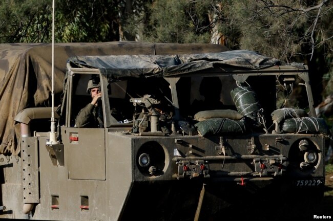 An Israeli soldier sits inside a military vehicle, near the Israel-Gaza border, in southern Israel, Jan. 15, 2024.