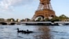FILE - Ducks swim along the Seine River in front of the Eiffel Tower during the 2024 Summer Olympics, July 29, 2024, in Paris. As the Olympics continue in Paris, the Seine River's water quality remains a major area of concern for officials. 