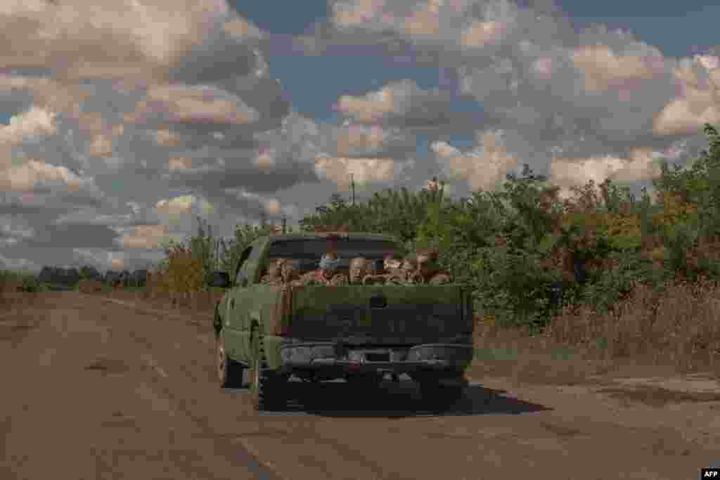 A Ukrainian military vehicle drives from the direction of the border with Russia carrying blindfolded men in Russian military uniforms, in the Sumy region, amid the Russian invasion of Ukraine.