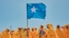 FILE - Students wave a Somali flag during a demonstration in support of Somalia's government following the port deal signed between Ethiopia and the breakaway region of Somaliland at Eng Yariisow Stadium in Mogadishu on Jan. 3, 2024.