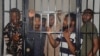 Protesters stand in a cell after a court hearing in Abuja, Nigeria, Sept. 2, 2024. 