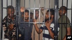 Protesters stand in a cell after a court hearing in Abuja, Nigeria, Sept. 2, 2024. 