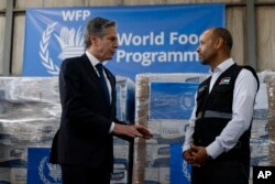 U.S. Secretary of State Antony Blinken, left, visits a World Food Program regional warehouse in Amman, Jordan, Jan. 7, 2024.