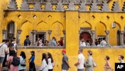 Tourists queue to visit the interior of the 19th century Pena Palace in Sintra, Portugal, Aug. 14, 2024.