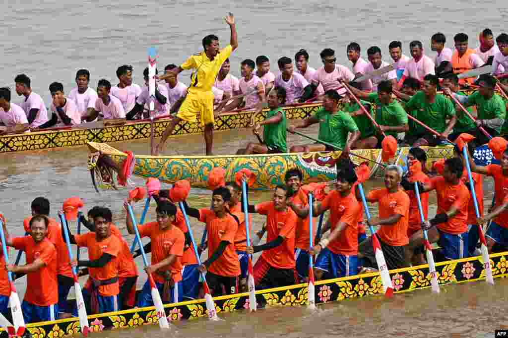 Participants row dragon boats during a competition as part of the Water Festival on the Tonle Sap river in Phnom Penh, Cambodia.