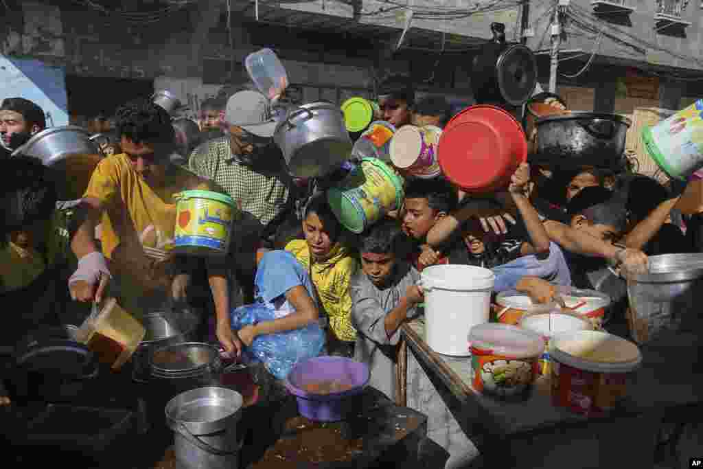 Palestinians crowded together as they wait for food distribution in Rafah, southern Gaza Strip.&nbsp;Since the start of the Israel-Hamas war, Israel has limited the amount of food and water allowed to enter the territory, causing widespread hunger across the strip.