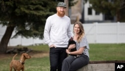 Aaron and Carrie Friesen pose for a photo with chickens and their dog Georgia in the back yard of their home in Boise, Idaho, on April 12, 2023. The couple and their three children recently moved to Idaho from the Bluffton, S.C., area.
