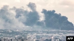 Smoke billows during Israeli bombardment on Khan Yunis from Rafah in the southern Gaza Strip early on Jan. 3, 2024.